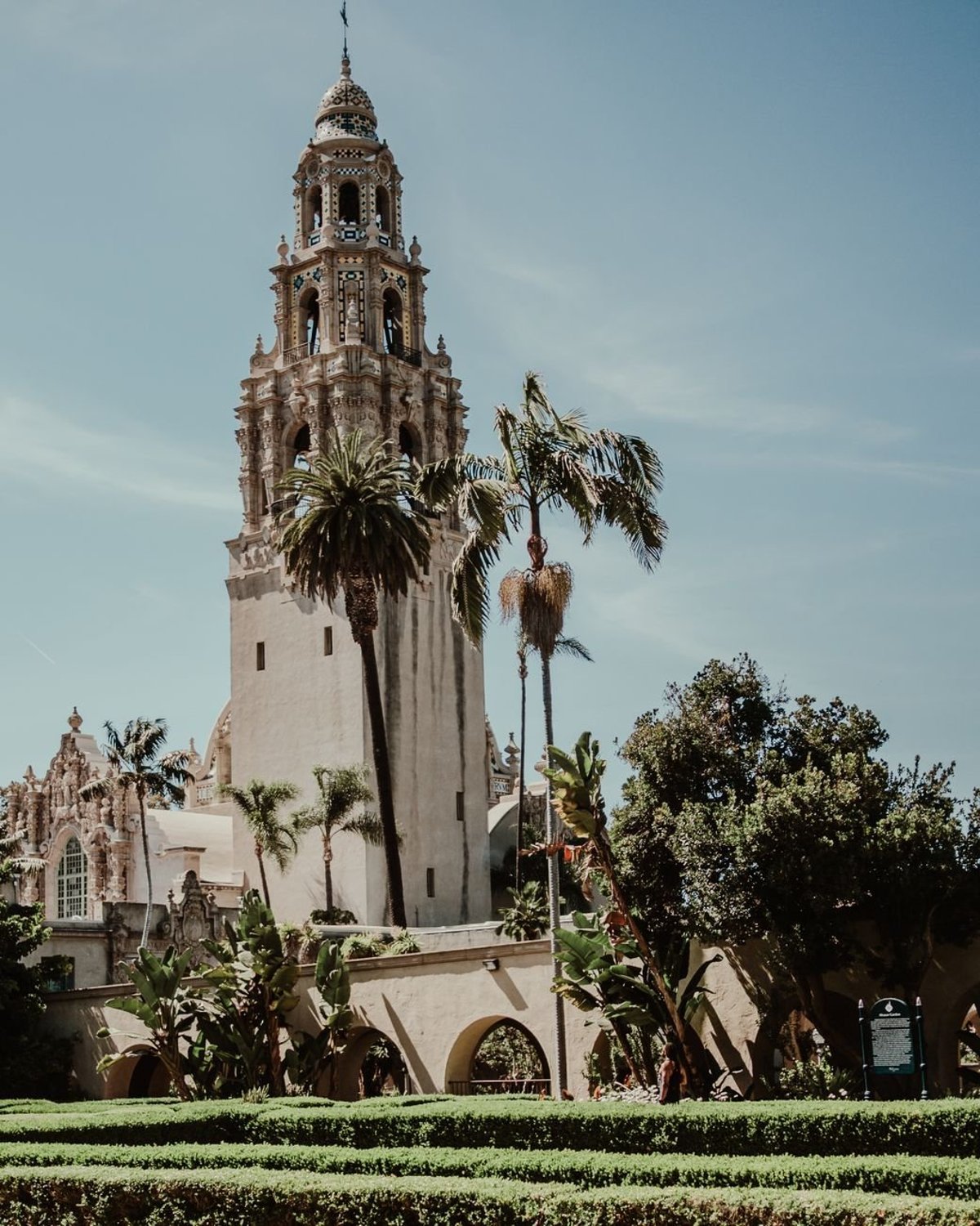 Spanish Colonial architecture and blooming gardens along El Prado in Balboa Park, San Diego