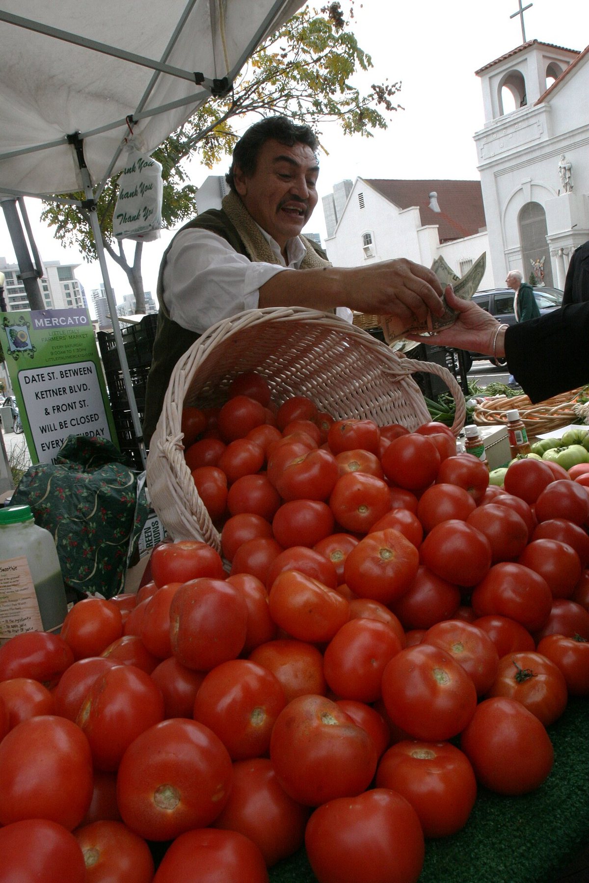 Produce and flower stalls at the Little Italy Mercato farmers market in downtown San Diego