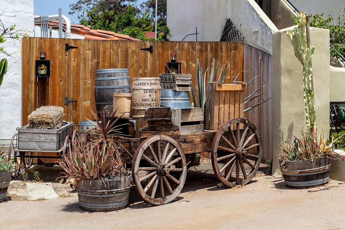 A wooden cart stacked with barrels and crates outside the shops at Old Town San Diego State Historic Park