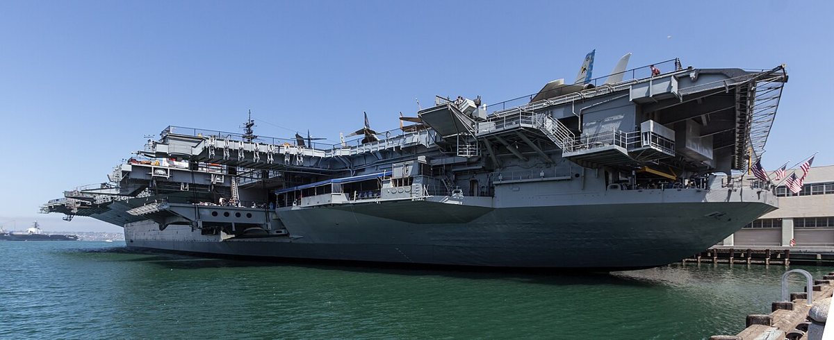 The USS Midway aircraft carrier docked on the San Diego waterfront with its flight deck open to visitors